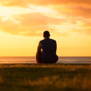 a psychic sat down, deep in thought, starring into the sunset.