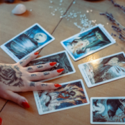 A Lady's hand touching some tarot cards