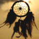 A dreamcatcher hanging outside in the sun