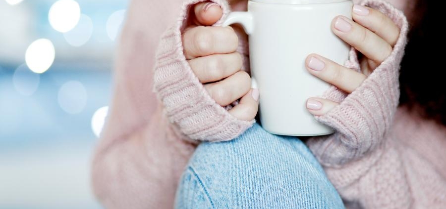 Lady holding a cup of coffee