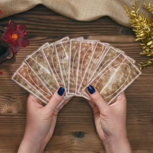 a psychic reader holding ancient gypsy cards