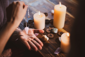 Psychic using a crystal, surrounded by candles