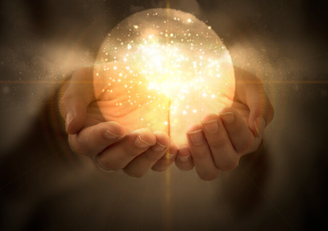 Magic Ball in woman's hands, glowing