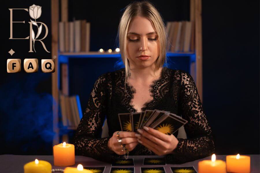 A psychic reader dealing tarot cards surrounded by candles