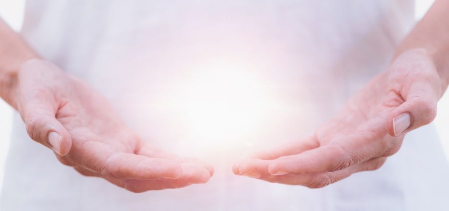 a healing psychic reader holding an aura in his hands