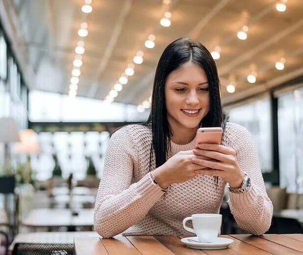 Woman using a rose gold Phone