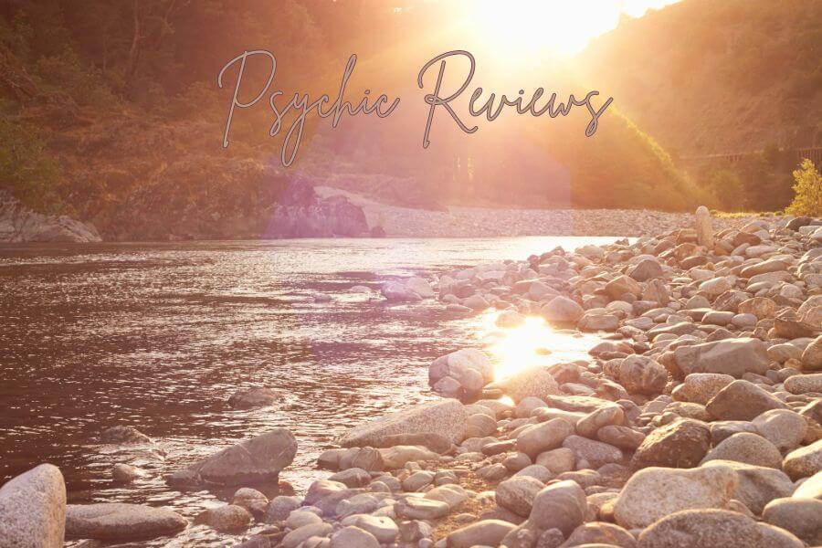 A tranquil lake with sunshine. The words Psychic Reviews floats in the air.